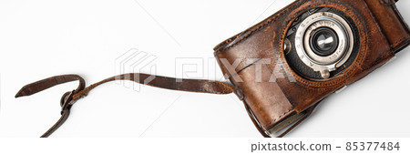 Old vintage camera with 35mm lens in brown leather case isolated on white background Old vintage camera with 35mm lens in brown leather case isolated on white background 85377484