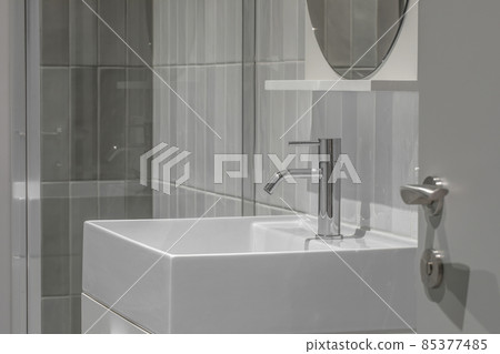 Modern furnished minimalist bathroom light grey interior design with metro style grey tiles Modern furnished minimalist bathroom light grey interior design with metro style grey tiles 85377485