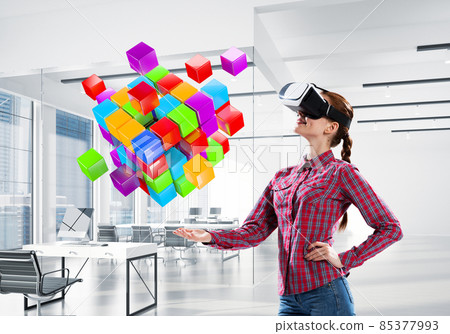 Girl in virtual reality mask experiencing virtual technology world. Mixed media Girl in virtual reality mask experiencing virtual technology world. Mixed media 85377993