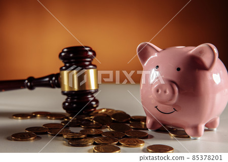 Gavel and ceramic piggy bank with coins close-up Gavel and ceramic piggy bank with coins close-up 85378201