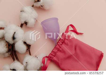 Reusable pastel purple menstrual cup with bag on a pink background. Top view. Eco-friendly and modern way of women's hygiene concept Reusable pastel purple menstrual cup with bag on a pink background. Top view. Eco-friendly and modern way of women's hygiene concept 85378257