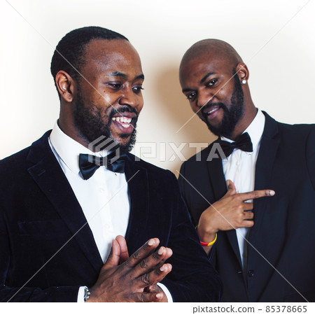 two african-american businessmen in black suits emotional posing, gesturing, smiling. wearing bow-ties two african-american businessmen in black suits emotional posing, gesturing, smiling. wearing bow-ties 85378665