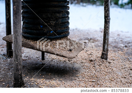 Manger for winter feeding of wild animals in forest. Forest animal feeder in winter. Defocused Manger for winter feeding of wild animals in forest. Forest animal feeder in winter. Defocused 85378833