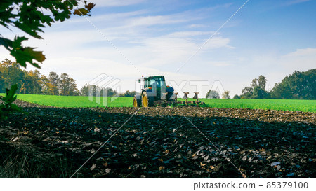 Tractor farm. Agriculture farm machinery on landscape land field. Farmer machine equipment for crop. Tractor farm fields concept. 85379100