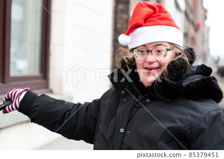 Happy 39 year old woman with Down Syndrome with a christmas cap Happy 39 year old woman with Down Syndrome with a christmas cap 85379451