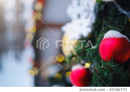 Beautiful decorated Christmas tree in a winter landscape with snow Beautiful decorated Christmas tree in a winter landscape with snow 85386733