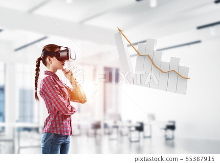 Girl in virtual reality mask experiencing virtual technology world. Mixed media Girl in virtual reality mask experiencing virtual technology world. Mixed media 85387915