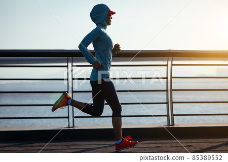 Fitness woman runner running on seaside bridge 85389552