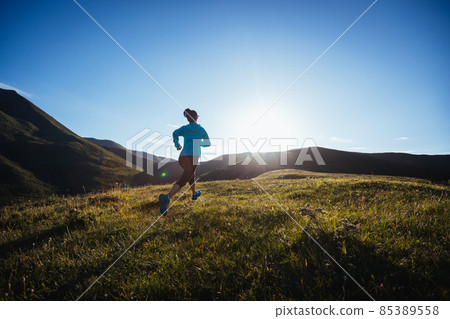 Woman ultramarathon runner running at mountain top 85389558