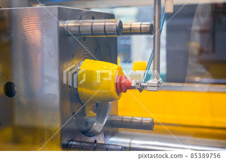 Injection molding machine during work: production of empty plastic cup: close up Injection molding machine during work: production of empty plastic cup: close up 85389756