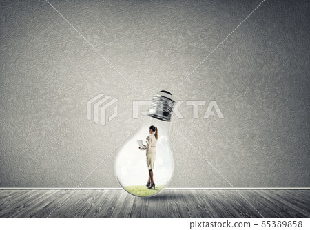 Businesswoman trapped in bulb Businesswoman trapped in bulb 85389858