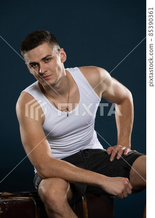 Seated portrait of a young and handsome model from Europe. 85390361