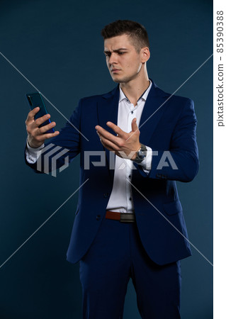 A businessman received a bad message on his cell phone. Disgruntled man. 85390388