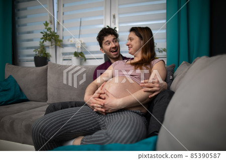 The husband exclaims with joy that he is going to have a son and the wife smiles warmly. Pregnant woman. The husband exclaims with joy that he is going to have a son and the wife smiles warmly. Pregnant woman. 85390587