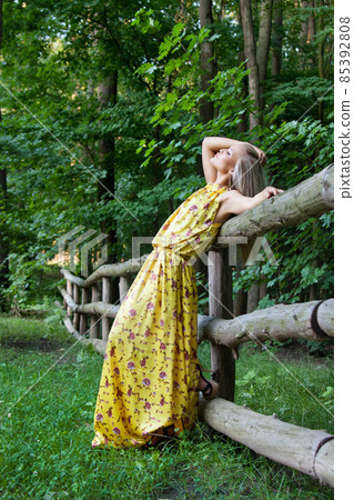 Sexy woman outdoor with nice yellow dress Sexy woman outdoor with nice yellow dress 85392808