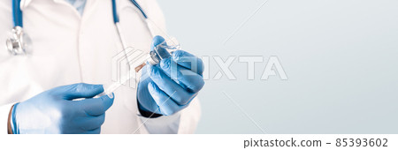 Doctor holding a vial with a vaccine Doctor holding a vial with a vaccine 85393602