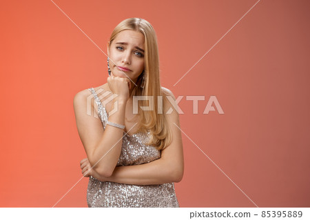 Bored uninterested careless attractive elegant young glamour blond woman lean head smirking indifferent feel boredom reluctant hear boring uninteresting story standing annoyed red background 85395889