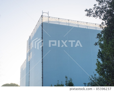 covered scaffholding protects a building under restoration covered scaffholding protects a building under restoration 85396237
