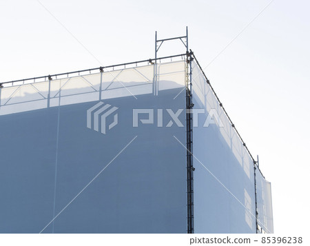 covered scaffholding protects a building under restoration covered scaffholding protects a building under restoration 85396238
