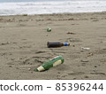 trash on the beach: beer bottles abandoned on the sand 85396244