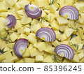 chopped raw potatoes with red onion slices and rosemary leaves 85396245