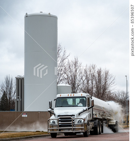 Liquid oxygen being unloaded from a semi truck into storage tanks at a medical facility in a residential district 85396507