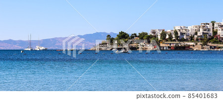 Blue sea, boats, mountains and small town on the coast of the Aegean sea. Summer holidays and coastal nature concept 85401683