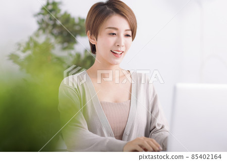 Young woman working  laptop  home  covid-19  85402164