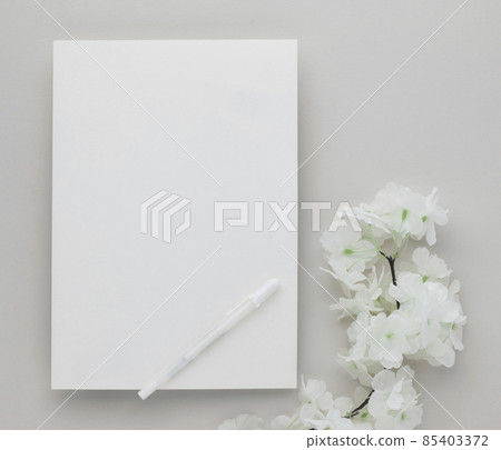 White invitation card mockup with a white flower on beige background, Minimal beige workplace composition, flat lay, mockup White invitation card mockup with a white flower on beige background, Minimal beige workplace composition, flat lay, mockup 85403372