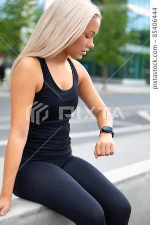 Resting Woman Checking Performance and Tracking On Smartwatch After Exercise Resting Woman Checking Performance and Tracking On Smartwatch After Exercise 85406444