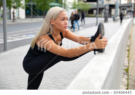 Gorgeous and Flexible Blonde Woman Stretching In Modern City Gorgeous and Flexible Blonde Woman Stretching In Modern City 85406445