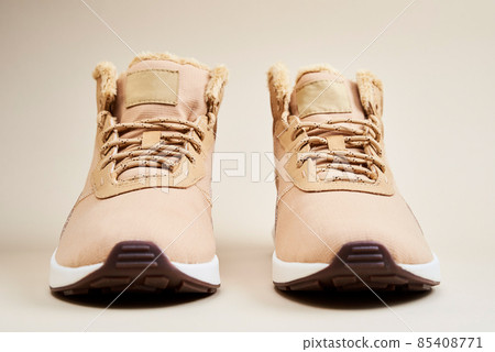 Male winter shoes on beige background 85408771