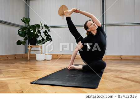 woman performing advanced level yoga postures. sports instructions. 85412019