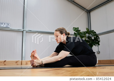yoga stretch of a Caucasian woman in sportswear 85412024