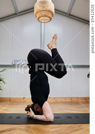 inverted yoga posture. over the head 85412026