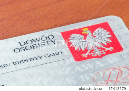 Close-up for fragment of Polish ID card on wooden table. 85412379