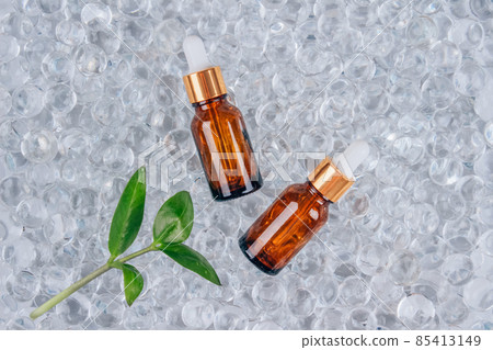 Dropper bottles of face anti aging serum with collagen and peptides on gel bubbles background with copy space. Cosmetic fluid collagen or essential oil. Skin care routine, mock up 85413149
