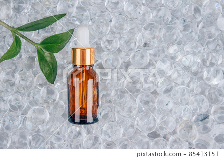 Mock up of dropper bottle with face anti aging serum with collagen and peptides on gel bubbles background with copy space. Cosmetic fluid collagen or essential oil. Skin care routine Mock up of dropper bottle with face anti aging serum with collagen and peptides on gel bubbles background with copy space. Cosmetic fluid collagen or essential oil. Skin care routine 85413151