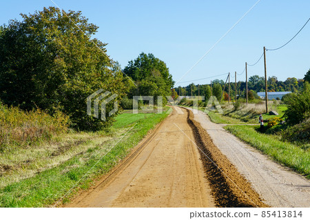 gravel road leveling in rural areas with the help of a grader 85413814