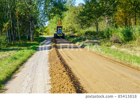 gravel road leveling in rural areas with the help of a grader 85413818
