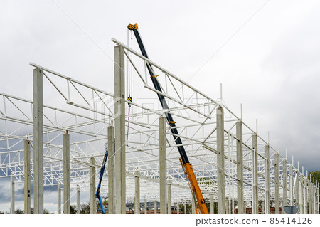 crane with telescopic boom in the assembly of metal structures of an industrial building crane with telescopic boom in the assembly of metal structures of an industrial building 85414126