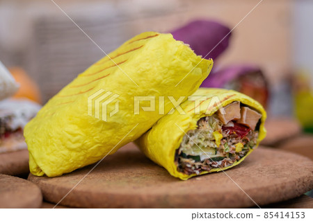 Fresh colorful vegan doner rolls with vegetables on counter at summer local food 85414153