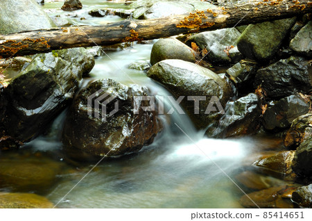 Long exposure view of a hidden river in Crimea, Ukraine. A stone set against a blurred water pattern is ideal for background use. 85414651
