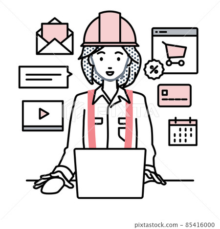 A woman at a construction site sitting at a desk and doing an online shop or marketing job on a PC 85416000