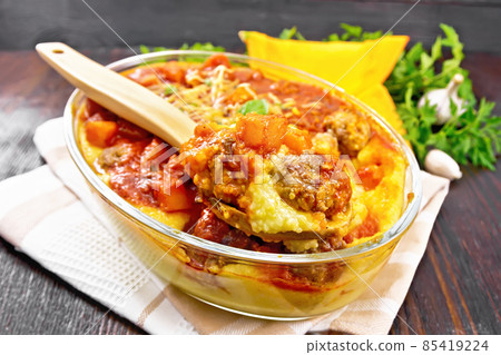 Porridge corn with meat and spoon in roaster on towel 85419224