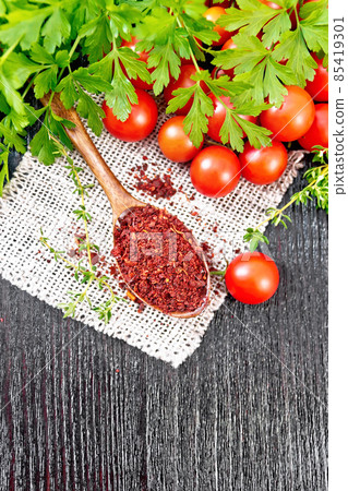 Tomatoes dried in spoon on wooden board top 85419301