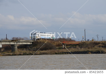 "Kamuysaurus (Mukawa Ryu) Reconstruction Train" departing from Hamaatsuma Station and approaching the Atsuma River Bridge 85421655