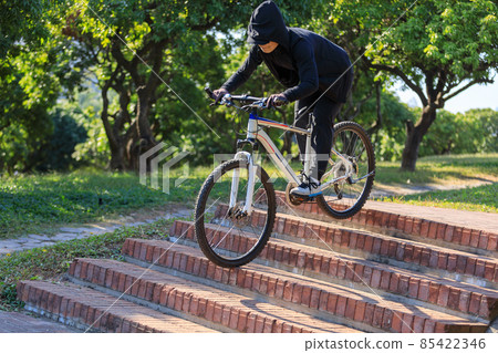Woman free rider riding bike going down city stairs Woman free rider riding bike going down city stairs 85422346