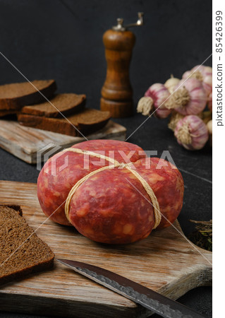 Smoked round beef sausage on cutting board Smoked round beef sausage on cutting board 85426399