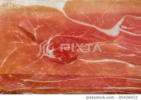 Macro photo of slices of dry-cured parma ham Macro photo of slices of dry-cured parma ham 85426412